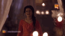 a woman in a red dress with a sony sab logo on the bottom right