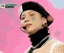 a close up of a person wearing a hat and a microphone with the words heart attack on the bottom right
