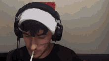 a person wearing headphones and a santa hat