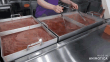 a person in a purple apron is stirring a tray of food in a kitchen made in animatica