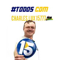 a man holds up a blue button with the number 15 on it