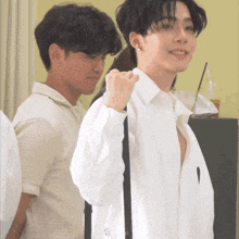 a man in a white shirt is standing next to a man in a white shirt