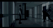 a man is laying on his stomach in a dark room next to a window .