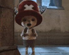 a stuffed animal with antlers and a red hat