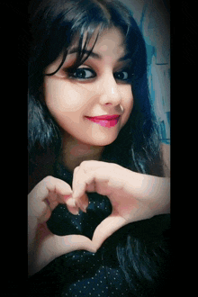 a woman making a heart with her hands