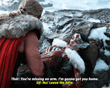thor is talking to a woman laying on a rock in the snow