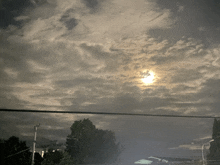 the sun is shining through the clouds above a house