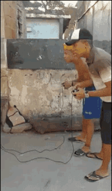 a man in a baseball cap is playing a video game outside