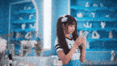 a girl wearing a shirt that says i love le is looking at her cell phone