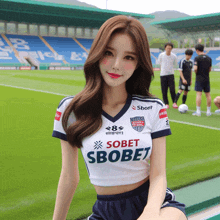 a girl wearing a soccer jersey that says sobet