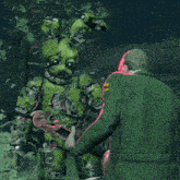 a man in a green coat is standing next to a green bunny robot