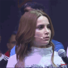 a woman wearing a white jacket with adidas on it