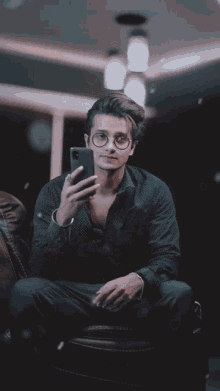 a young man taking a selfie with his phone