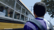 a boy looking out the window of a school bus that says young shock on the side