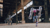 a man in a robot costume is standing in a warehouse