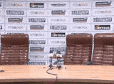 a row of chairs in front of a wall that says persona on it