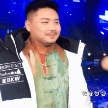a man is wearing a jacket that says raiffeisen helvetica and bkw