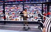 a wrestler is walking out of a wrestling ring with a referee behind him
