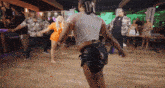 a group of people are dancing in a room with a sign that says zeus on it