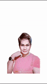 a woman in a pink shirt is standing in front of a stage with lights behind her