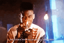 a man is smoking a cigarette and saying " dat cookie was callin me "