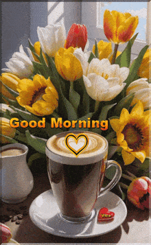 a cup of coffee sits on a saucer next to a bouquet of flowers and the words good morning