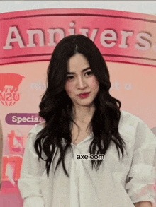 a woman in front of a sign that says annivers on it