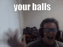 a blurry picture of a man with glasses and the words your balls behind him