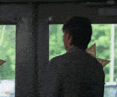 a man standing in front of a door with a star on the window