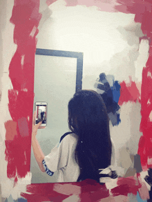 a girl is taking a picture of herself in a mirror with a shirt that says ' athletic ' on the sleeve