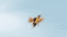 a man in a yellow and black superhero costume is flying in the sky