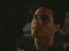 a close up of a man 's face with his eyes closed .