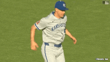 a baseball player wearing a blue hat with the letter p on it