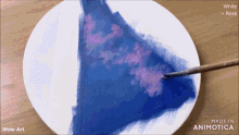 a white plate with a brush on it that says wow art made in animatica