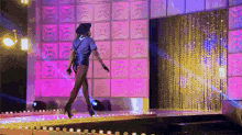 a woman in a police uniform is walking down a runway on a stage .