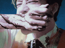 a man in a suit and tie is holding a piece of chocolate in his hand
