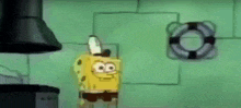 spongebob squarepants is standing in a kitchen with a life preserver on the wall behind him .