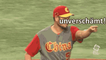 a man in a baseball uniform is pointing at something with the word unverschammt written above him .