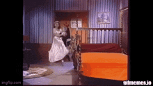 a woman in a white dress is dancing in a room with an orange bed ..