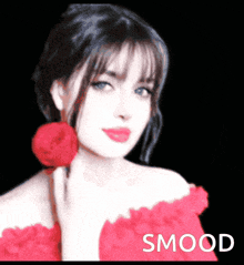 a woman in a red dress is holding a red rose in front of a black background with smood written on it