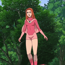 a woman in a pink superhero costume stands in front of a forest