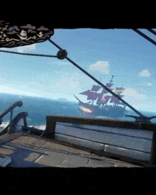 a view of a pirate ship from a boat in the ocean .