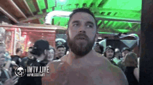 a man with a beard is standing in front of a crowd with the words jwtv live on the bottom right