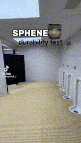 a bathroom with urinals and a sign that says ' sphene durability test ' on it