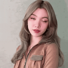 a close up of a woman 's face with her eyes closed