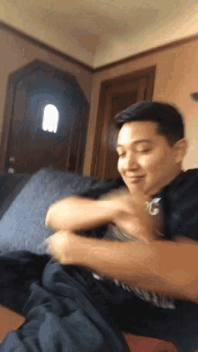 a man laying on a couch with his eyes closed