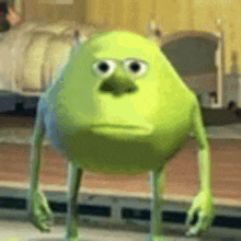 mike wazowski from monsters inc is standing on the floor in a room .