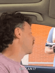 a man in a car talking to another man with the words or can i written on the bottom
