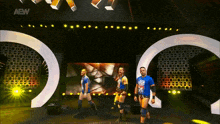 a group of wrestlers are walking on a stage with a aew logo on the bottom