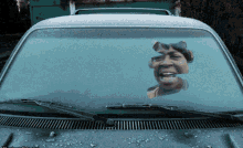 a car with a sticker of a woman 's face on its windshield